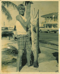 Capt. Tim Carlile with a toothy barracuda standing on N. Roosevelt Blvd. near Charter Boat Row in Key West